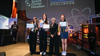 Maria (centre) and teammates presenting their solution a the Women and Girls in STEM Forum in Brussels, 2023