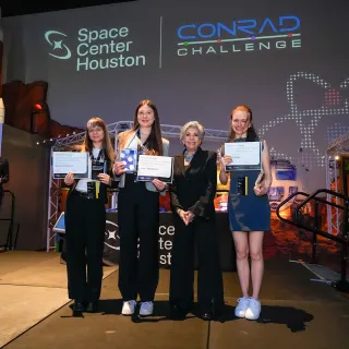Maria (centre) and teammates presenting their solution a the Women and Girls in STEM Forum in Brussels, 2023