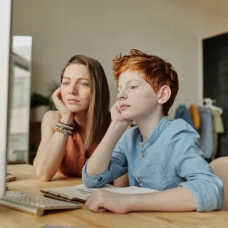 photo-of-woman-and-boy-leaning-on-wooden-table-4145353